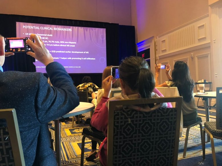 Attendees photographing a presentation slide with their phones